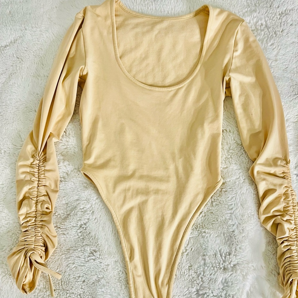 High cut bodysuit with cinched sleeves
